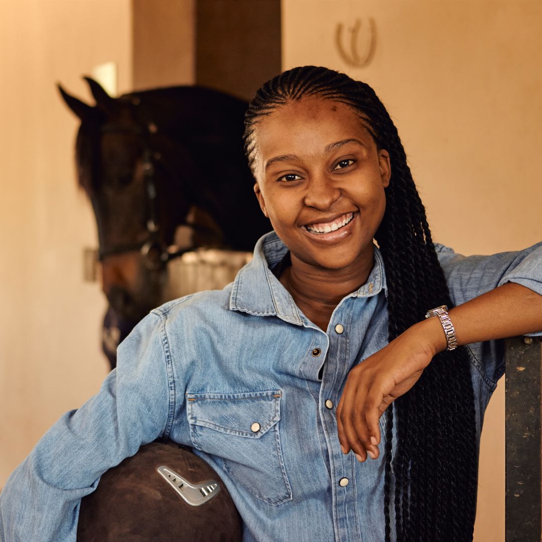 Lady smiling in front of a horse