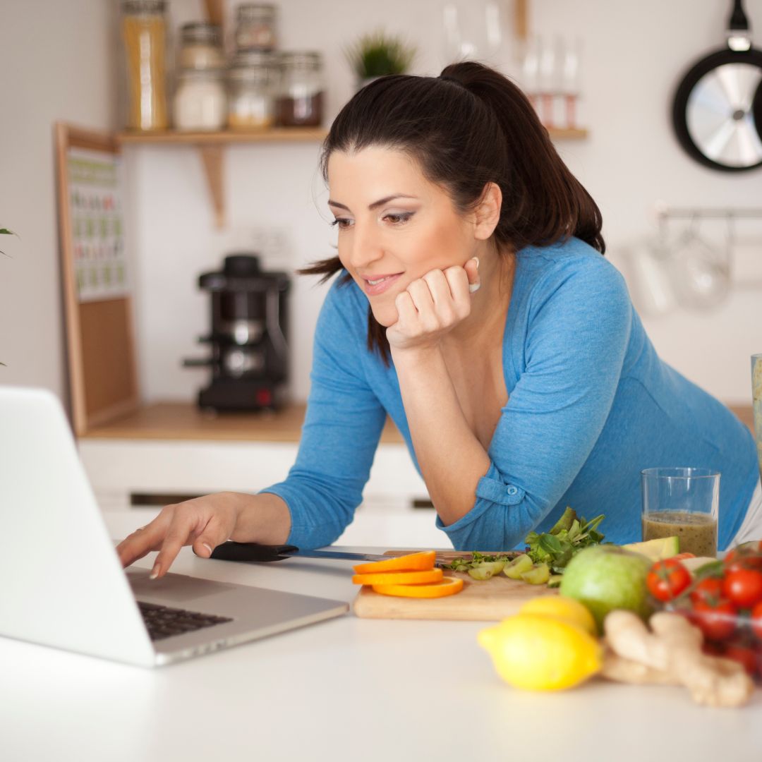 Woman with a laptop in the kitchen