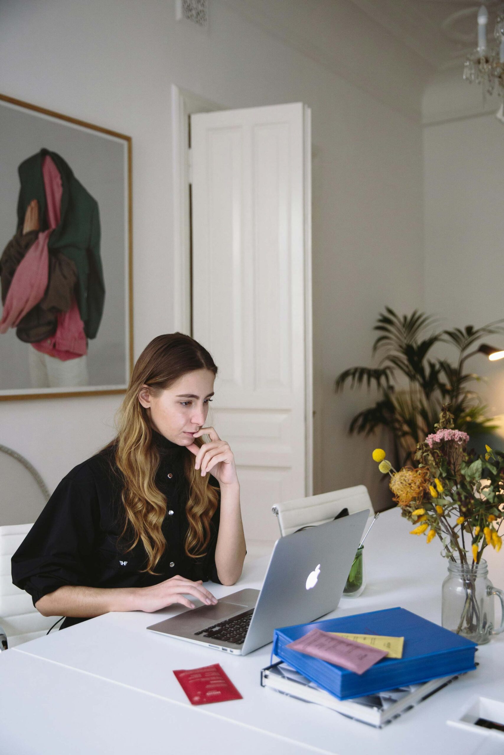 Woman using mousepad of MacBook laptop